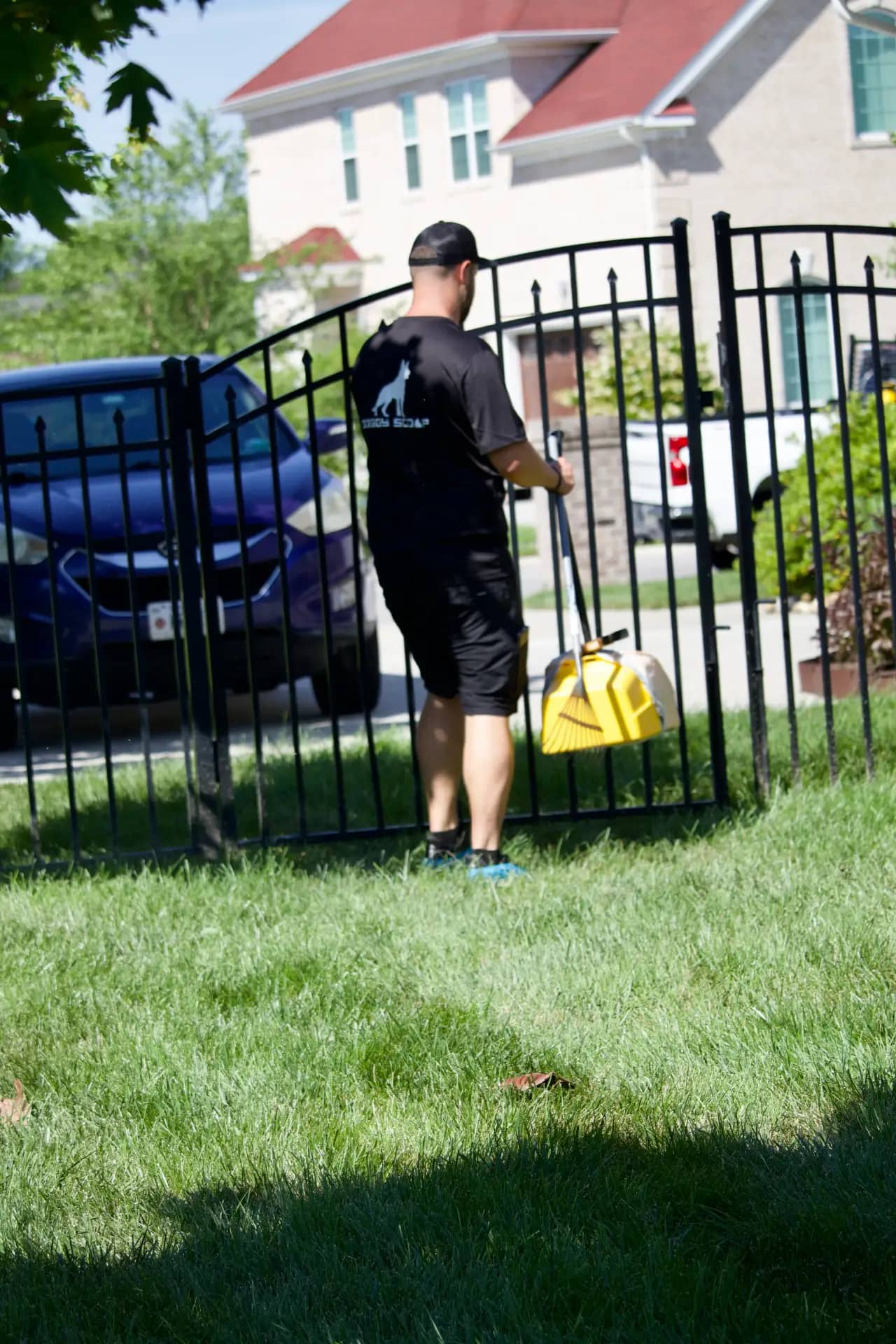 Doggy Scoop technician servicing a commercial property gate area