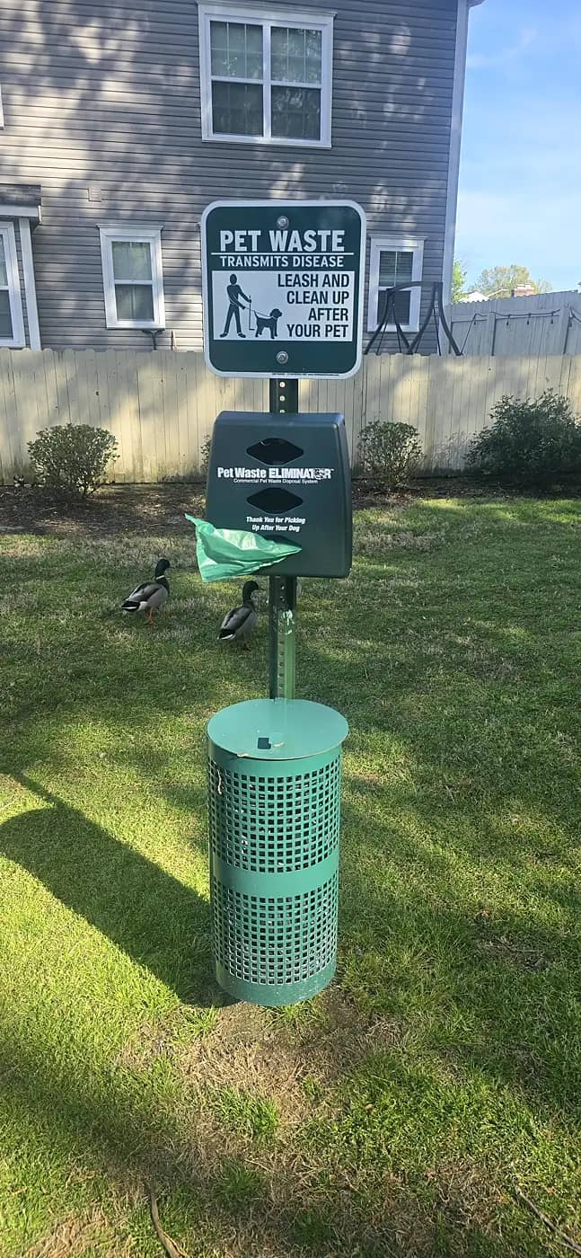 Commercial dog waste station maintenance and cleanup Complete pet waste station installed in an apartment community green space